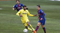 HUESCA, SPAIN - JANUARY 23: &Eacute;tienne Capoue of Villareal CF challenges Jaime Seoane of SD Huesca during the La Liga Santander match between SD Huesca and Villarreal CF at Estadio El Alcoraz on January 23, 2021 in Huesca, Spain. Sporting stadiums aro