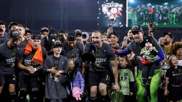 LOS ANGELES, CALIFORNIA - DECEMBER 02: Giorgio Chiellini #14 of Los Angeles FC holds up the trophy while using a bullhorn to speak to fans, surrounded by teammates and family, in celebration of a 2-0 win over the Houston Dynamo in the Western Conference Final at BMO Stadium on December 02, 2023 in Los Angeles, California.   Harry How/Getty Images/AFP (Photo by Harry How / GETTY IMAGES NORTH AMERICA / Getty Images via AFP)
