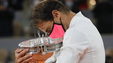 Spain's Rafael Nadal holds the trophy as he celebrates winning the final match of the French Open tennis tournament against Serbia's Novak Djokovic in three sets, 6-0, 6-2, 7-5, at the Roland Garros stadium in Paris, France, Sunday, Oct. 11, 2020. (AP Photo/Christophe Ena)