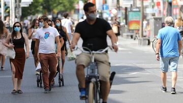 Cyclists and predestrians wear protective facemasks as they travel on a street in Antwerp on August 6, 2020, as authorities impose additional measures to attempt to curb the spread of the COVID-19 caused by the novel coronavirus&quot;. - The country with the highest number of deaths attributed to coronavirus compared to its population is Belgium with 85 fatalities per 100,000 inhabitants, followed by the UK at 68, Peru 61, Spain 61, and Italy 58. (Photo by FranxE7ois WALSCHAERTS / AFP)
