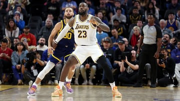 Stephen Curry #30 of the Golden State Warriors matches up against LeBron James #23 of the Los Angeles Lakers in overtime at Chase Center on January 27, 2024 in San Francisco, California.