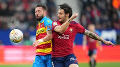 PAMPLONA, SPAIN - MARCH 19: David Garcia of CA Osasuna tackles Juan Cruz of Levante during the LaLiga Santander match between CA Osasuna and Levante UD at Estadio El Sadar on March 19, 2022 in Pamplona, Spain. (Photo by Juan Manuel Serrano Arce/Getty Imag