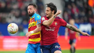 PAMPLONA, SPAIN - MARCH 19: David Garcia of CA Osasuna tackles Juan Cruz of Levante during the LaLiga Santander match between CA Osasuna and Levante UD at Estadio El Sadar on March 19, 2022 in Pamplona, Spain. (Photo by Juan Manuel Serrano Arce/Getty Imag