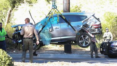 Tiger Woods' smashed up SUV is loaded onto a flatbed truck and removed from California crash scene.