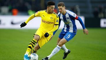 Dortmund's English midfielder Jadon Sancho (L) vies for the ball with Hertha Berlin's German defender Niklas Stark during the German first division Bundesliga football match Hertha Berlin v Borussia Dortmund in Berlin, Germany on November 30, 20