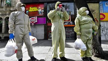13 May 2020, Bolivia, La Paz: People wearing protective suits stand in a deserted street after buying food amid the lockdown and the Martial Law due to the spread of the coronavirus pandemic. Photo: Christian Lombardi/ZUMA Wire/dpa
13/05/2020 ONLY FO