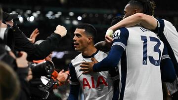 Tottenham Hotspur's Spanish defender #23 Pedro Porro (C) celebrates with teammates and supporters after scoring his team third goalduring the English Premier League football match between Manchester City and Tottenham Hotspur at the Etihad Stadium in Manchester, north west England, on November 23, 2024. (Photo by Paul ELLIS / AFP) / RESTRICTED TO EDITORIAL USE. No use with unauthorized audio, video, data, fixture lists, club/league logos or 'live' services. Online in-match use limited to 120 images. An additional 40 images may be used in extra time. No video emulation. Social media in-match use limited to 120 images. An additional 40 images may be used in extra time. No use in betting publications, games or single club/league/player publications. /