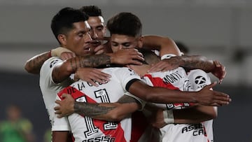 River Plate's defender Gonzalo Montiel (hidden) celebrates with teammates after scoring, by penalty kick, the team's second goal against Rosario Central during an Argentine Professional Football League match, at the Monumental stadium in Buenos Aires, on February 20, 2021. (Photo by ALEJANDRO PAGNI / AFP)