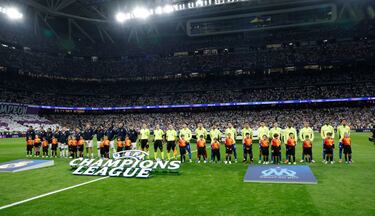 Los jugadores del Real Madrid y Marsella posan en el centro del campo del estadio Santiago Bernabéu.