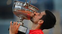 Serbia's Novak Djokovic kisses The Mousquetaires Cup (The Musketeers) after winning against Greece's Stefanos Tsitsipas at the end of their men's final tennis match on Day 15 of The Roland Garros 2021 French Open tennis tournament in Paris on June 13, 202