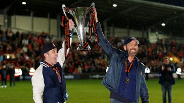FILE PHOTO: Soccer Football - National League - Wrexham v Boreham Wood - Racecourse Ground, Wrexham, Britain - April 22, 2023 Wrexham co-owners Rob McElhenney and Ryan Reynolds celebrate with the trophy on the pitch after Wrexham win the National League and promotion to League Two Action Images via Reuters/Ed Sykes EDITORIAL USE ONLY. No use with unauthorized audio, video, data, fixture lists, club/league logos or 'live' services. Online in-match use limited to 75 images, no video emulation. No use in betting, games or single club /league/player publications. Please contact your account representative for further details./File Photo