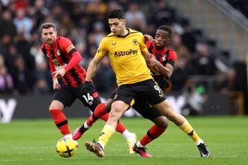 WOLVERHAMPTON, ENGLAND - FEBRUARY 18: Raul Jimenez of Wolverhampton Wanderers is tackled by Hamed Junior Traore of AFC Bournemouth during the Premier League match between Wolverhampton Wanderers and AFC Bournemouth at Molineux on February 18, 2023 in Wolverhampton, England. (Photo by Richard Heathcote/Getty Images)