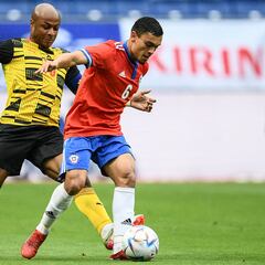 Ghana's Andre Ayew (L) and Chile's Nayel Mehssatou compete for the ball during the Kirin Cup football match between Chile and Ghana at Panasonic stadium in Suita, Osaka prefecture on June 14, 2022. (Photo by CHARLY TRIBALLEAU / AFP)