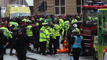 Members of the emergency services treat members of the public inside a Police cordon at the scene of an incident on Water Street, on the sidelines of an open-top bus victory parade for Liverpool's Premier League title win, in Liverpool, north-west England on May 26, 2025. (Photo by Darren Staples / AFP)