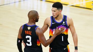 Jul 6, 2021; Phoenix, Arizona, USA; Phoenix Suns guard Devin Booker (1) speaks with guard Chris Paul (3) against the Milwaukee Bucks during the second half in game one of the 2021NBA Finals at Phoenix Suns Arena. Mandatory Credit: Mark J. Rebilas-USA TODAY Sports
