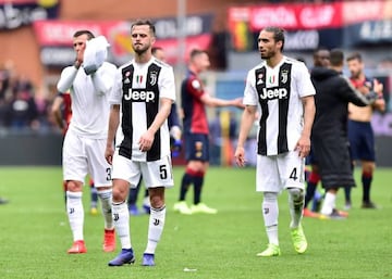 Juventus' Miralem Pjanic and Martin Caceres react after a rare domestic defeat.