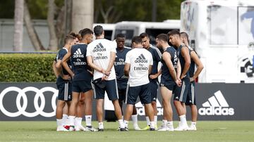 The players listen to orders from a member of the coaching staff.