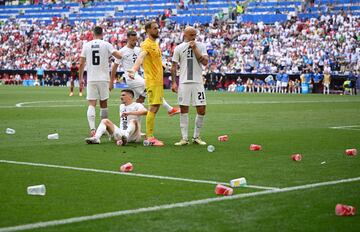 El césped del Football Arena lleno de Vasos de cerveza durante el duelo entre Eslovenia y Serbia.