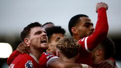 Liverpool's Scottish defender #26 Andrew Robertson (L) celebrates the team's third goal during the English Premier League football match between Fulham and Liverpool at Craven Cottage in London on April 21, 2024. (Photo by BENJAMIN CREMEL / AFP) / RESTRICTED TO EDITORIAL USE. No use with unauthorized audio, video, data, fixture lists, club/league logos or 'live' services. Online in-match use limited to 120 images. An additional 40 images may be used in extra time. No video emulation. Social media in-match use limited to 120 images. An additional 40 images may be used in extra time. No use in betting publications, games or single club/league/player publications. / 