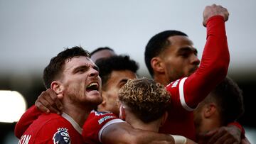 Liverpool's Scottish defender #26 Andrew Robertson (L) celebrates the team's third goal during the English Premier League football match between Fulham and Liverpool at Craven Cottage in London on April 21, 2024. (Photo by BENJAMIN CREMEL / AFP) / RESTRICTED TO EDITORIAL USE. No use with unauthorized audio, video, data, fixture lists, club/league logos or 'live' services. Online in-match use limited to 120 images. An additional 40 images may be used in extra time. No video emulation. Social media in-match use limited to 120 images. An additional 40 images may be used in extra time. No use in betting publications, games or single club/league/player publications. /