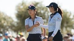 Team US golfer Andrea Lee (L) shakes hands with team US' Rose Zhang on the second day of the 2023 Solheim Cup biennial team golf competition.