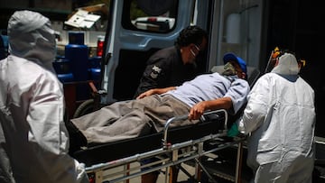 NEZAHUALCOYOTL, MEXICO - JUNE 18: Paramedics of Nezahualcoyotl, transports a patient with probable COVID-19 to an ambulance to be taken to a hospital during the answer to an emergency call on June 18, 2020 in Nezahualcoyotl, Mexico. Everyday, paramedics on one ambulance crew during a 12-hour shift respond to over ten emergency calls and between five and six are coronavirus related. (Photo by Manuel Velasquez/Getty Images)