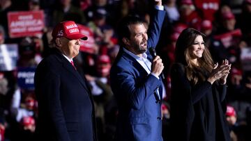 US President Donald Trump and Kimberly Guilfoyle listen while Donald Trump Jr. speaks during a Make America Great Again rally at Kenosha Regional Airport in Kenosha, Wisconsin.