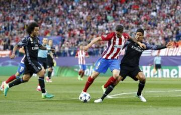 Raphael Varane brings down Atlético striker Fernando Torres to concede a penalty.