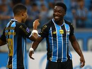 Gremio's Belgian midfielder #09 Francis Amuzu (R) celebrates with teammate Gremio's Colombian forward #99 Jose Enamorado after scoring his team's first goal during the Copa Sudamericana group stage football match between Brazil's Gremio and Argentina's Deportivo Riestra at the Arena do Gremio stadium in Porto Alegre, state of Rio Grande do Sul, Brazil, on April 14, 2026. (Photo by SILVIO AVILA / AFP)