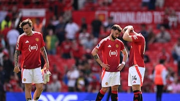 Manchester United's Swedish defender #02 Victor Lindelof (L), Manchester United's Portuguese midfielder #08 Bruno Fernandes (C) and Manchester United's Danish midfielder #14 Christian Eriksen (R) react to their defeat on the pitch after the English Premier League football match between Manchester United and West Ham United at Old Trafford in Manchester, north west England, on May 11, 2025. West Ham won the game 2-0. (Photo by Oli SCARFF / AFP) / RESTRICTED TO EDITORIAL USE. No use with unauthorized audio, video, data, fixture lists, club/league logos or 'live' services. Online in-match use limited to 120 images. An additional 40 images may be used in extra time. No video emulation. Social media in-match use limited to 120 images. An additional 40 images may be used in extra time. No use in betting publications, games or single club/league/player publications. /