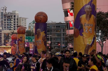 Lakers fans mill around "Kobe Land," a stretch of Chick Hearn Court in downtown Los Angeles that was closed to traffic Monday night, Dec. 18, 2017, as the Lakers got set to retire superstar Kobe Bryant's numbers in a halftime ceremony during the game agai