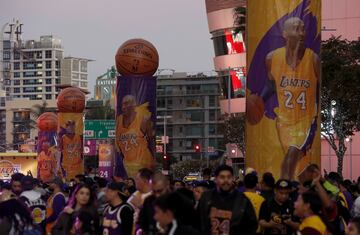 Lakers fans mill around "Kobe Land," a stretch of Chick Hearn Court in downtown Los Angeles that was closed to traffic Monday night, Dec. 18, 2017, as the Lakers got set to retire superstar Kobe Bryant's numbers in a halftime ceremony during the game agai