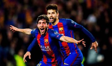 Piqué (background) celebrates with Sergi Roberto after the full-back's tie-winning goal against PSG.