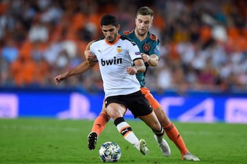 Ajax's Joel Veltman challenges Valencia's Goncalo Guedes during the UEFA Champions League Group H football match.