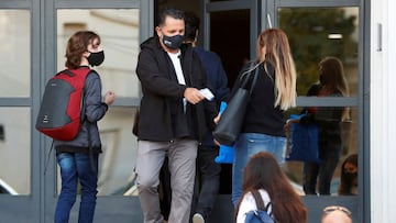 FILE PHOTO: A school employee checks the temperature of a woman as they arrive at school, amid a rise in coronavirus disease (COVID-19) cases , in Buenos Aires, Argentina April 19, 2021. REUTERS/Agustin Marcarian/File Photo