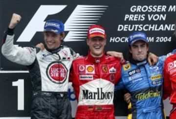 Jenson Button en el podio junto Michael Schumacher y Fernando Alonso.