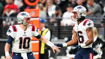 LAS VEGAS, NEVADA - DECEMBER 18: Mac Jones #10 of the New England Patriots and Jakobi Meyers #16 reacts during the first half against the Las Vegas Raiders at Allegiant Stadium on December 18, 2022 in Las Vegas, Nevada.   Chris Unger/Getty Images/AFP (Photo by Chris Unger / GETTY IMAGES NORTH AMERICA / Getty Images via AFP)