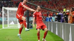 DOHA, QATAR - NOVEMBER 21: Gareth Bale of Wales celebrates with Kieffer Moore after scoring their team's first goal via a penalty past Matt Turner of United States during the FIFA World Cup Qatar 2022 Group B match between USA and Wales at Ahmad Bin Ali Stadium on November 21, 2022 in Doha, Qatar. (Photo by David Ramos - FIFA/FIFA via Getty Images)