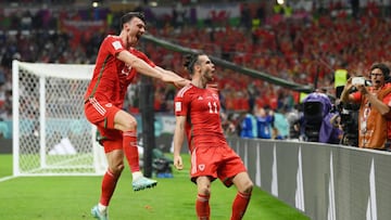 DOHA, QATAR - NOVEMBER 21: Gareth Bale of Wales celebrates with Kieffer Moore after scoring their team's first goal via a penalty past Matt Turner of United States during the FIFA World Cup Qatar 2022 Group B match between USA and Wales at Ahmad Bin Ali Stadium on November 21, 2022 in Doha, Qatar. (Photo by David Ramos - FIFA/FIFA via Getty Images)