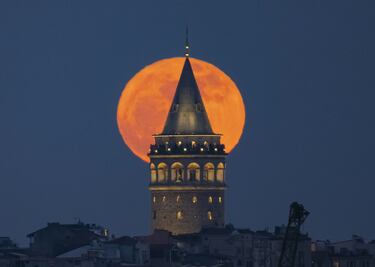 La luna llena se alza tras la Torre de Gálata en Estambul, Turquía.