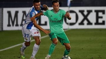 Leganes' Spanish midfielder Oscar Rodriguez (L) challenges Real Madrid's Spanish forward Lucas Vazquez during the Spanish league football match Club Deportivo Leganes SAD against Real Madrid CF at the Estadio Municipal Butarque in Leganes on July 19, 2020