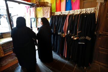 Dos mujeres ante una tienda de abayas (túnica tradicional femenina) de Souq Waqif.  