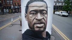MANCHESTER, UNITED KINGDOM - JUNE 03: Floral tributes lay next to a mural of George Floyd, by street artist Akse, in Manchester&#039;s northern quarter on June 03, 2020 in Manchester, United Kingdom. The death of an African-American man, George Floyd, whi