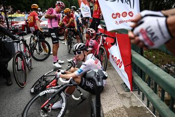 30 ciclistas se cayeron antes del km 30 de la etapa, este accidente obligo a detener la carrera durante unos minutos. En la imagen se ve al ciclista esloveno del UAE Team Emirates, Tadej Poga?ar esperando en el suelo la reanudaci¨®n de la carrera.