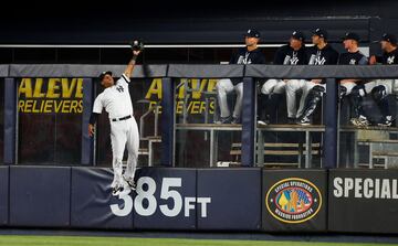El jugador de los New York Yankees Aaron Hicks, atrapa la bola durante el partido ante los Tampa Bay Rays, bajo la atenta mirada de sus compañeros.