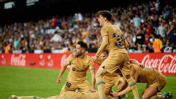 Robert Lewandowski (bottom) of FC Barcelona celebrates after scoring their side's first goal with his teammates during the LaLiga Santander match between Valencia CF and FC Barcelona at Mestalla stadium, October 29, 2022, Valencia, Spain. (Photo by David Aliaga/NurPhoto via Getty Images)