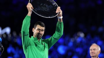 Serbia�s Novak Djokovic raises the runner-up shield after his defeat to Spain�s Carlos Alcaraz in the men�s singles final on Day 15 of the Australian Open. tennis tournament in Melbourne on February 1, 2026. (Photo by Martin KEEP / AFP) / -- IMAGE RESTRICTED TO EDITORIAL USE - STRICTLY NO COMMERCIAL USE --