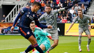 FC Cincinnati forward Brandon Vázquez, left, scores during the first half of an MLS soccer match against CF Montreal, Saturday, April 2, 2022, in Cincinnati. (AP Photo/Jeff Dean)