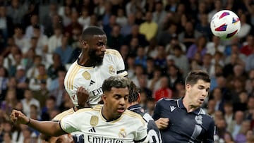 Real Madrid's German defender #22 Antonio Rudiger (up) heads the ball during the Spanish Liga football match betweem Real Madrid and Real Sociedad at at the Santiago Bernabeu stadium in Madrid on September 17, 2023. (Photo by Pierre-Philippe MARCOU / AFP)