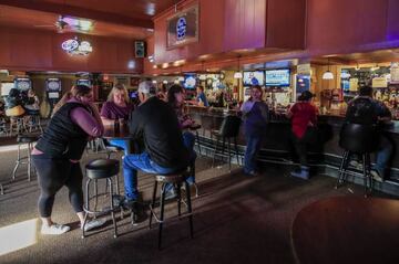 Customers talk and drink at the Somewhere bar in Fond du Lac, Wisconsin, USA, 14 May 2020.